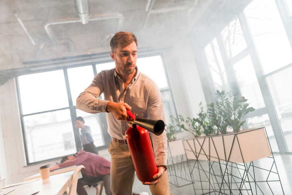 Man Using Fire Extinguisher